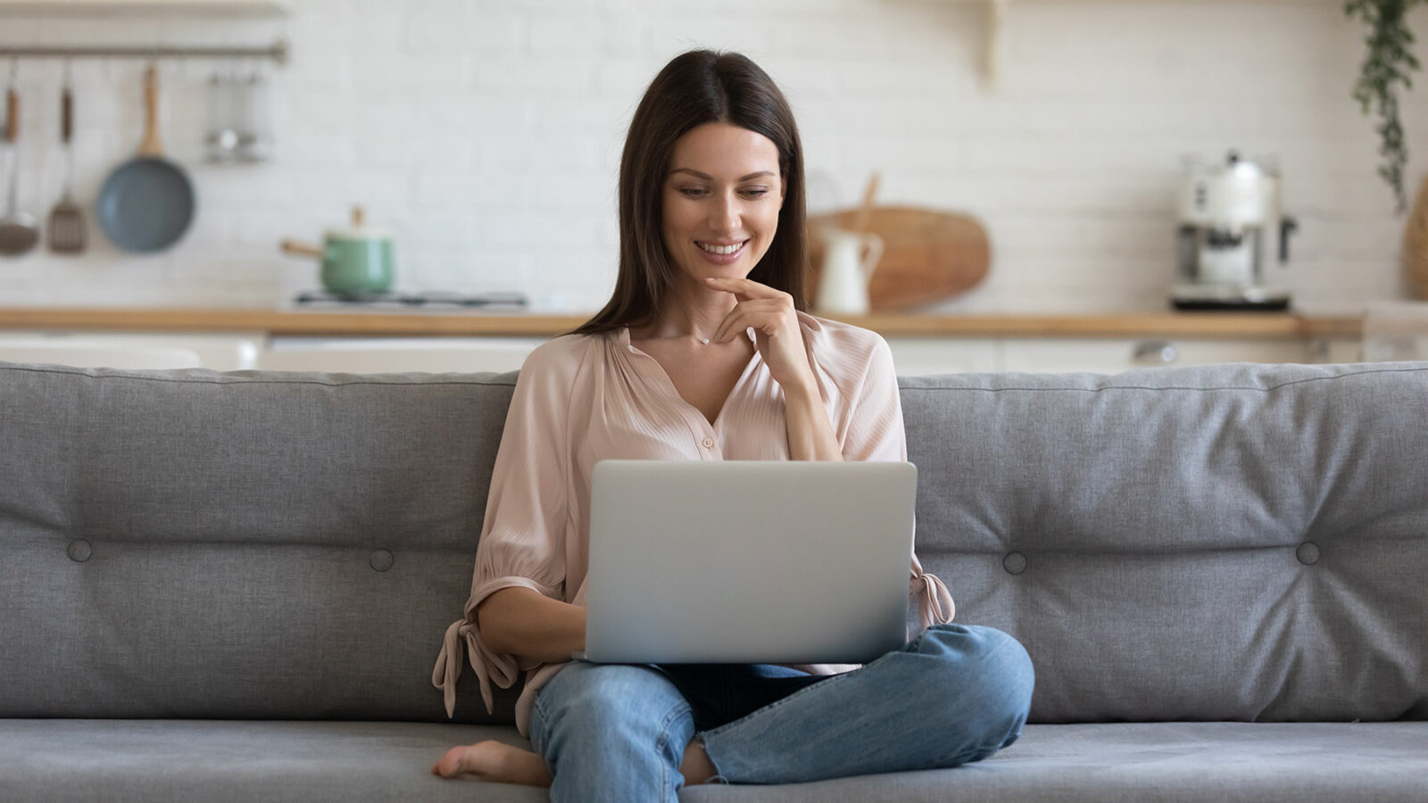 Smiling young woman using laptop | Xtreme Carpet Care