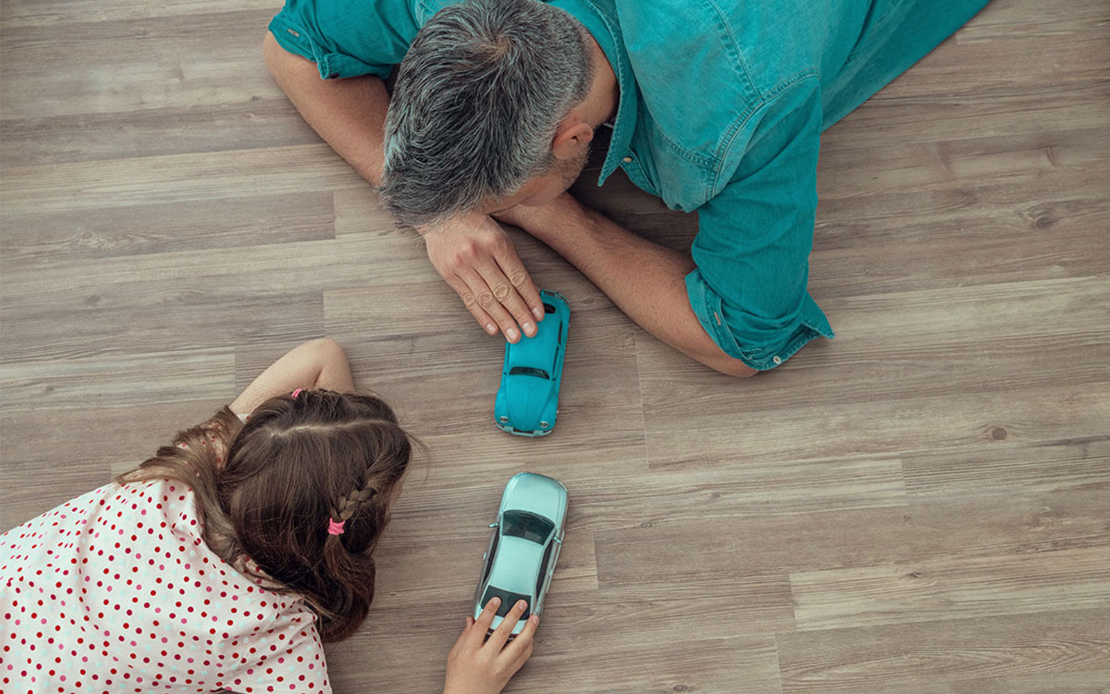 Kid with father playing with toycar | Xtreme Carpet Care