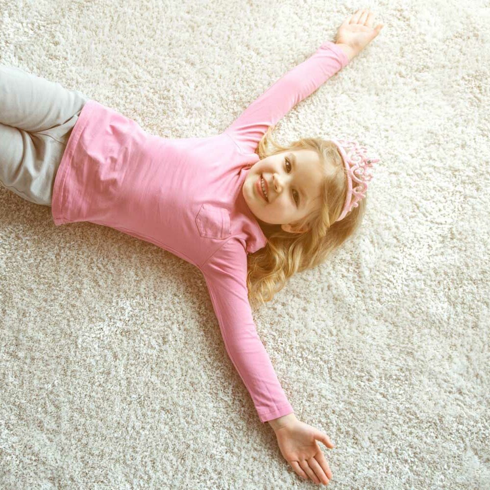 Girl laying on area rug | Xtreme Carpet Care